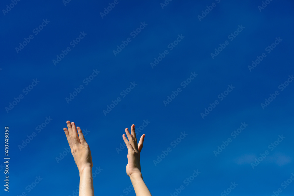 I wish we could touch the sky, female stretching hands to blue sky I wish we could touch the sky, female stretching hands to blue sky