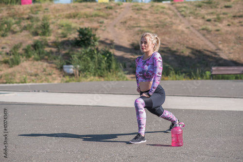 Wallpaper Mural Beautiful and sportive blonde girl doing lunges on a street sports ground Torontodigital.ca