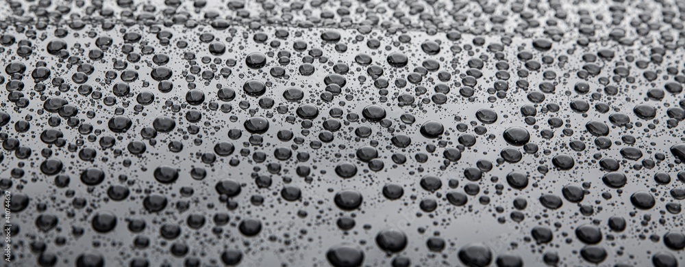 Water drops on car paint. Hydrophobic water effect on car body after using ceramic coating