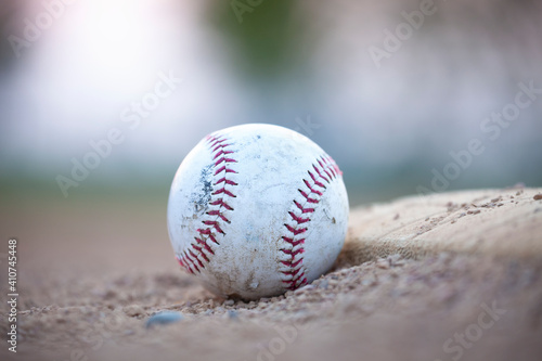 Selective focus low angle view of an old baseball next to a base
