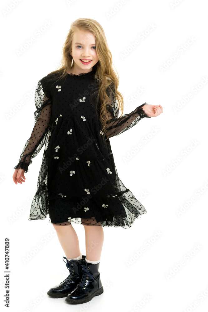 Fototapeta premium Little girl in an elegant dress.The concept of a happy childhood