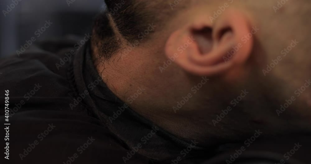 Man hairdresser makes beard contour with trimmer for his client in barbershop Man hairdresser makes beard contour with trimmer for his client in barbershop