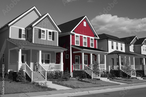 Fototapeta Naklejka Na Ścianę i Meble -  Selective red color in a black and white photo of a row of suburban houses