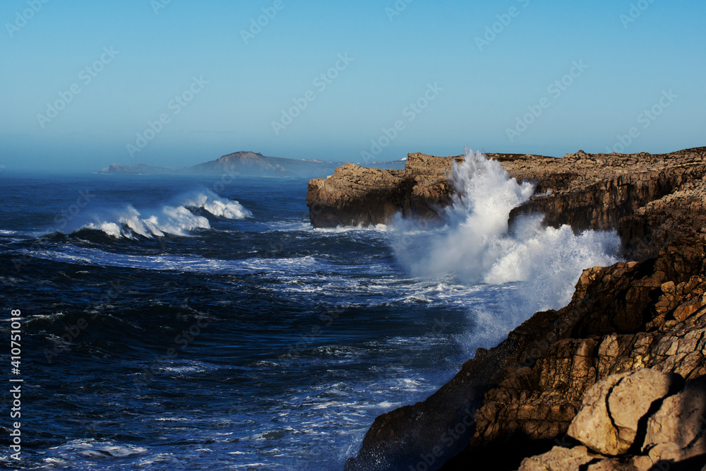 Huge waves hitting the cliff and exploding Huge waves hitting the cliff and exploding