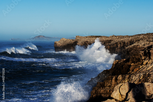 Huge waves hitting the cliff and exploding