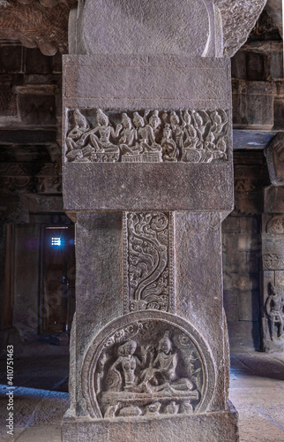 Bagalakote, Karnataka, India - November 7, 2013: Pattadakal temple complex. Closeup of gray stone pillar with sculpted teaching scenery, Virupaksha temple. photo