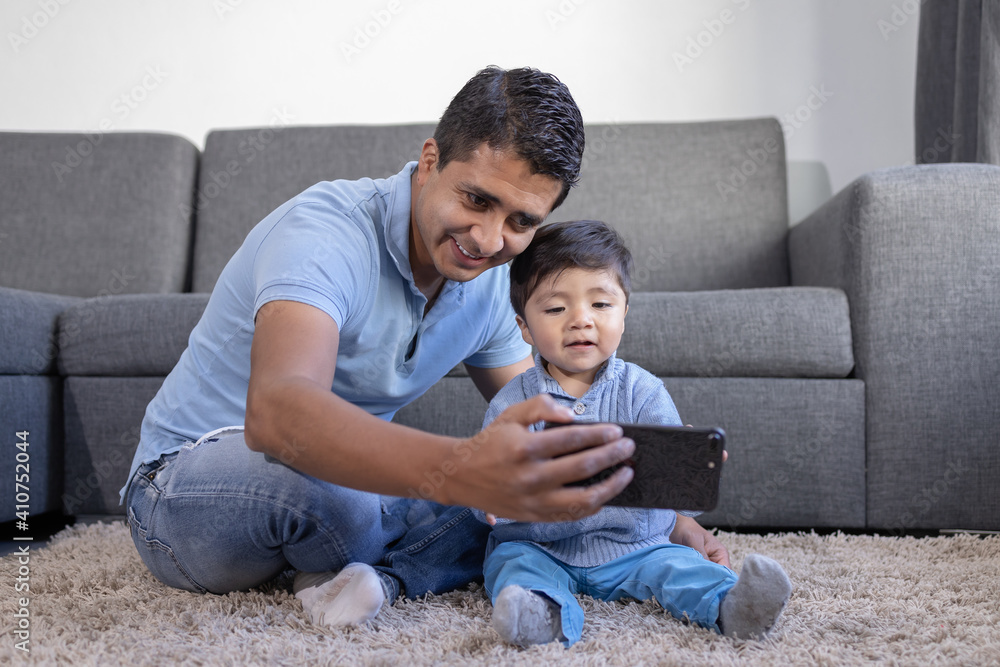 Mexican father and child doing video call at home, father's day 