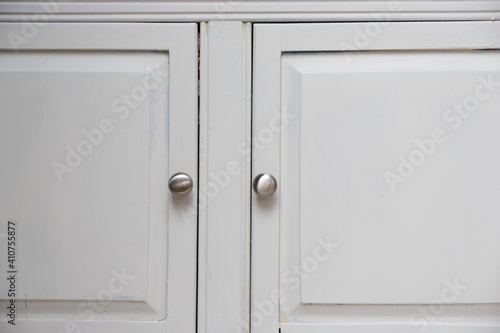 Silver knobs on white cabinet doors on an American Home Kitchen