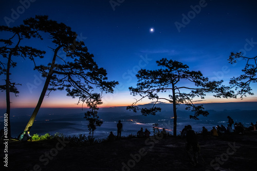 Silhouette Tourists on Pha Nok Aen Phukradueng, Thailand in the morning. photo