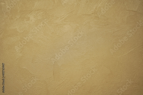Abstract gold background with plaster texture on wall