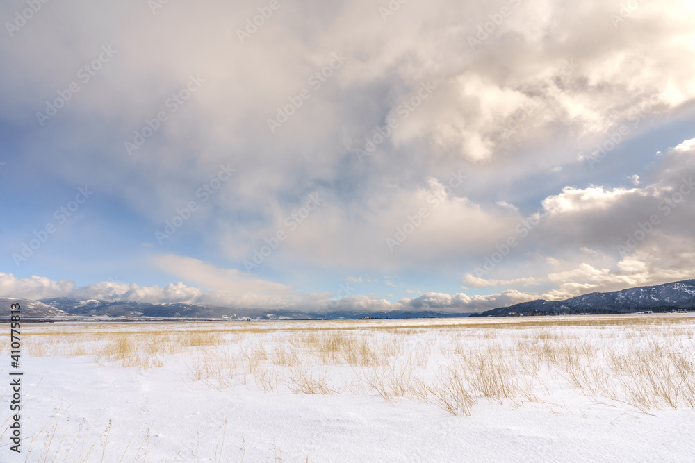 Snow Covered Field in Teton Valley Idaho with Clouds and Mountains