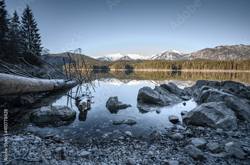 Beatuiful shot of a rocky lake with mountains in the horizon photo