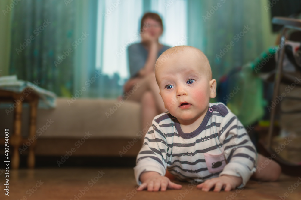 A small child masters the space under the supervision of a mother. A small child masters the space under the supervision of a mother.