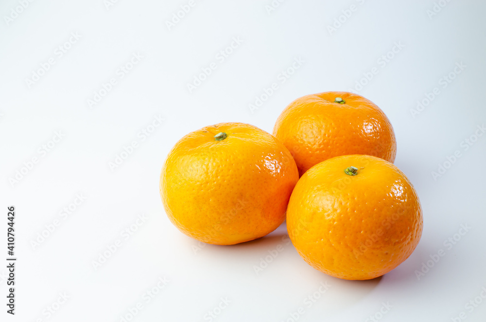 Orange on white background isolated, Asian tropical fruits whole good for healthy drinks and juice. Very natural sweet flavor. Tangerine, mandarine, Thai honey sweet green. Close up shot food concept Orange on white background isolated, Asian tropical fruits whole good for healthy drinks and juice. Very natural sweet flavor. Tangerine, mandarine, Thai honey sweet green. Close up shot food concept