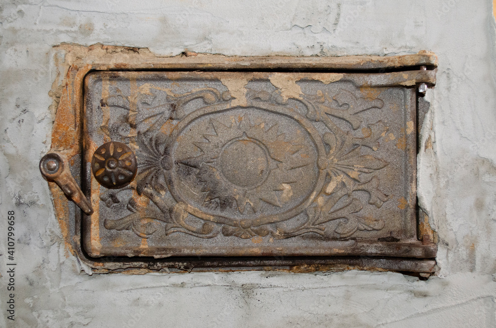 carved metal door to the stove