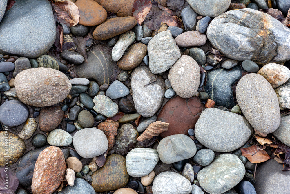 A shallow river, a rocky bottom with a dry riverbed against the background of autumn weather in nature and small pebbles. A shallow river, a rocky bottom with a dry riverbed against the background of autumn weather in nature and small pebbles.