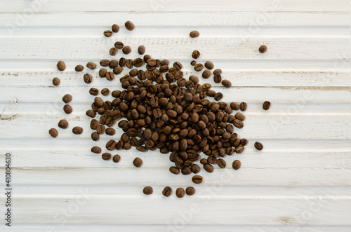 coffee beans scattered on white wooden background