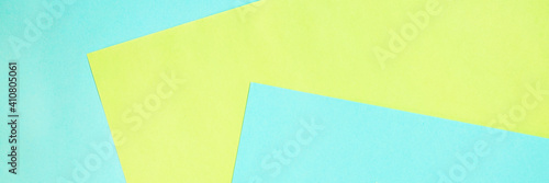 Geometric composition from colored paper. Light blue yellow abstract background. Colorful background with copy space for design. Web banner.