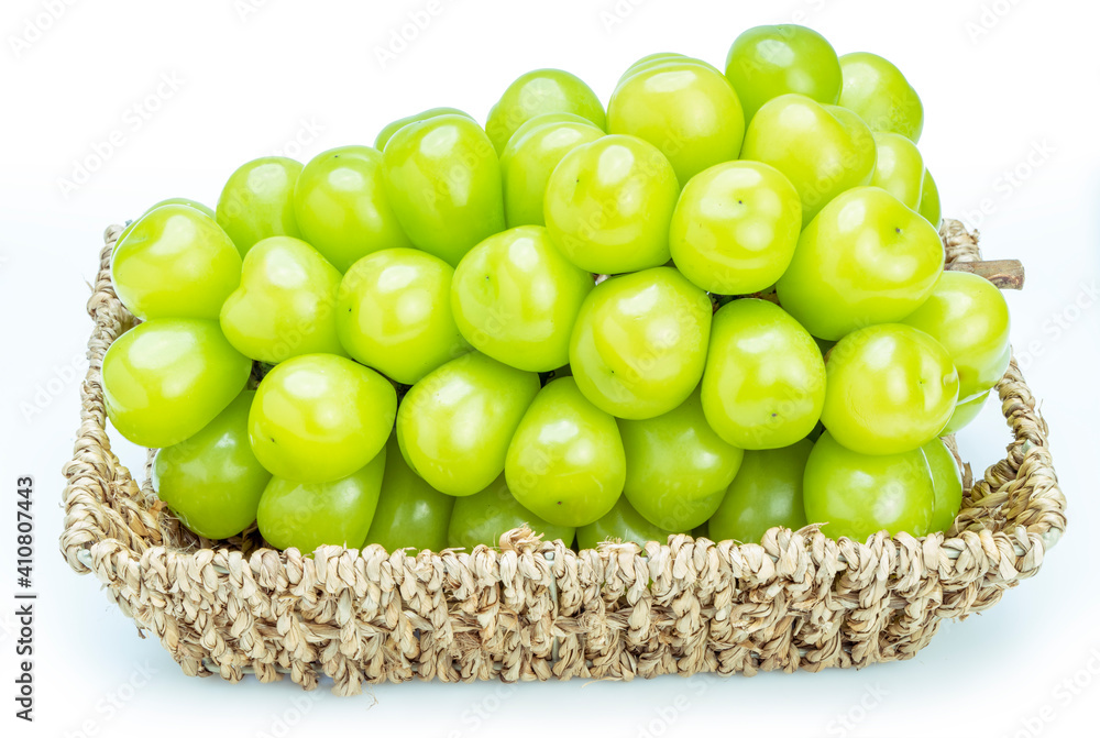 Shine Muscat Grape in Bamboo basket isolated on white background, Green grape isolated on white. Shine Muscat Grape in Bamboo basket isolated on white background, Green grape isolated on white.