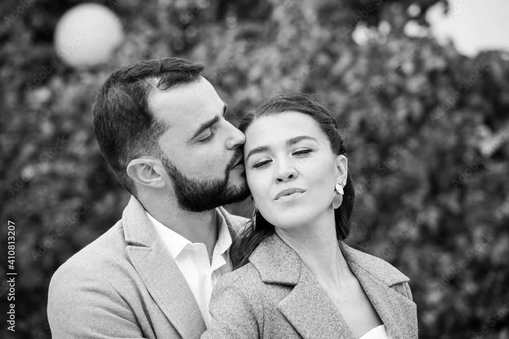 Stylish couple in gray coats gently hugging on the background of autumn leaves. Happy sensual wedding couple embracing. Romantic moments of newlyweds. Stylish couple in gray coats gently hugging on the background of autumn leaves. Happy sensual wedding couple embracing. Romantic moments of newlyweds.