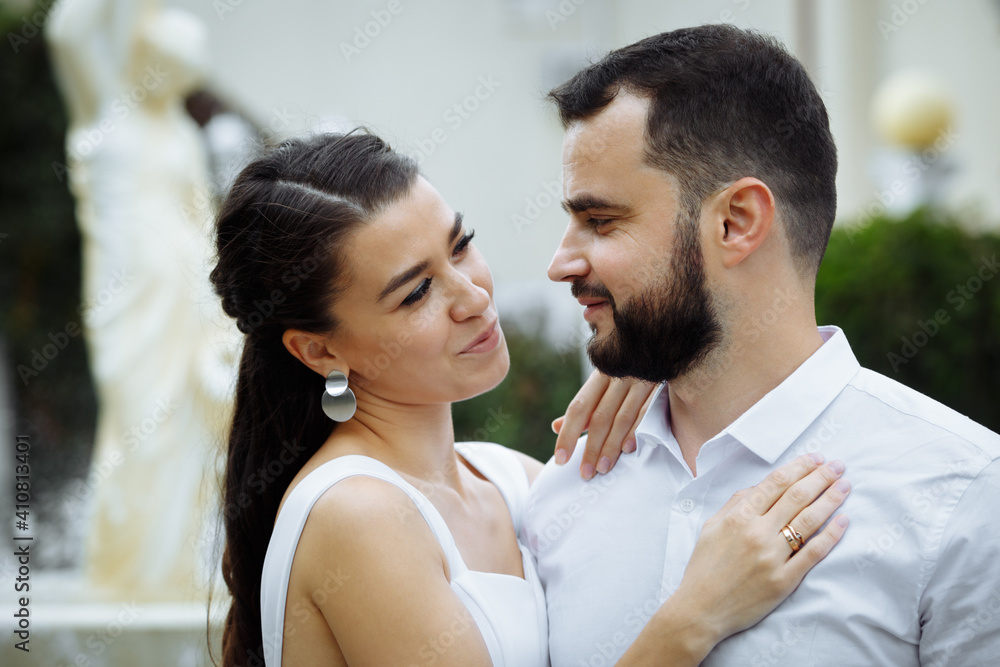 Stylish couple gently hugging on the background of the fountain. Happy sensual wedding couple embracing. Romantic moments of newlyweds. Stylish couple gently hugging on the background of the fountain. Happy sensual wedding couple embracing. Romantic moments of newlyweds.