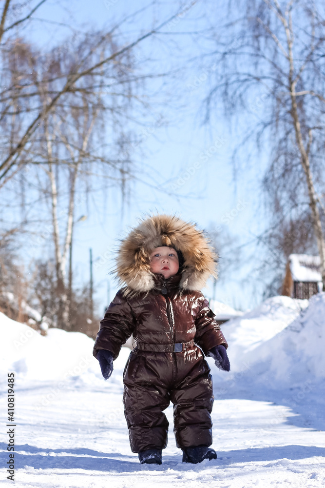 A cute little boy having fun outdoors on a winter day. Wintertime, entertainment, activity, childhood, holidays concept. A cute little boy having fun outdoors on a winter day. Wintertime, entertainment, activity, childhood, holidays concept.