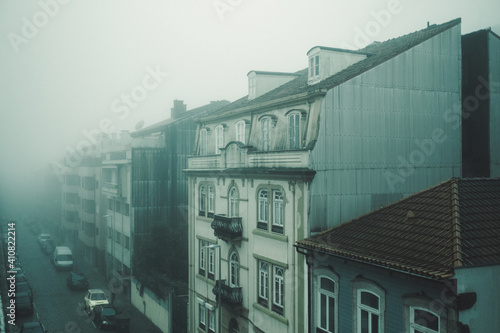 View of the buildings on foggy street in Porto, Portugal.