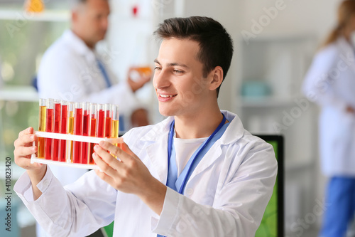 Male scientist holding samp...