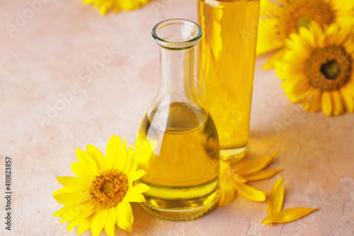 Bottle of sunflower oil on color background