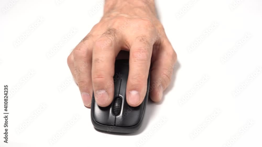 Isolated on a White Background. An Old Man's Hand Holds a Wireless Computer Mouse on the Table. Click and Move. Isolated on a White Background. An Old Man's Hand Holds a Wireless Computer Mouse on the Table. Click and Move.