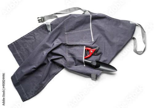 Apron and gardening tools on white background