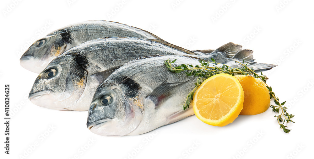 Raw dorado fish with lemon on white background Raw dorado fish with lemon on white background