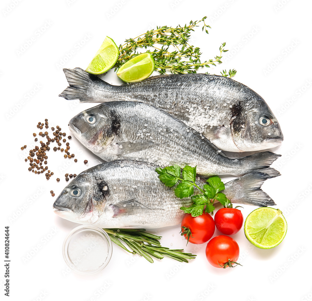 Raw dorado fish with ingredients on white background Raw dorado fish with ingredients on white background