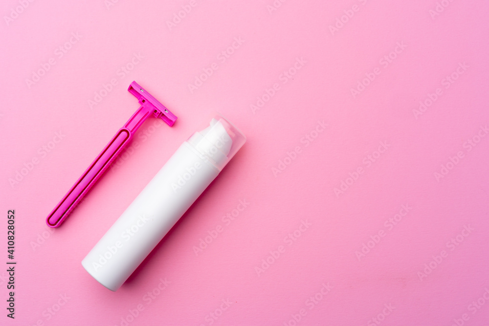 Shaving gel and disposable shaver on pink background top view Shaving gel and disposable shaver on pink background top view