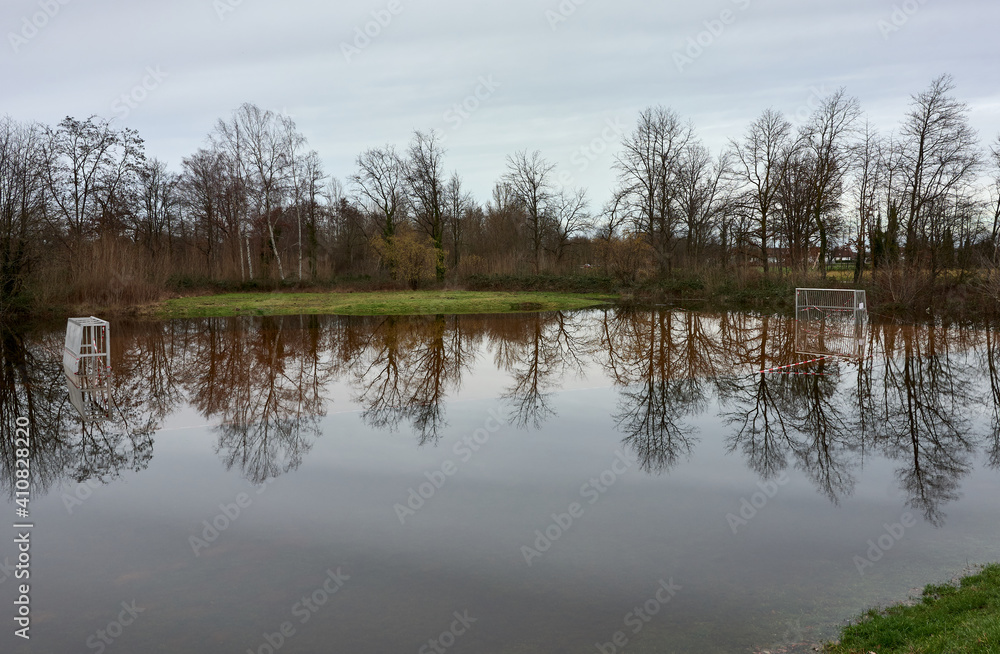 Flooded grass football field after heavy rain in Rastatt, Germany.