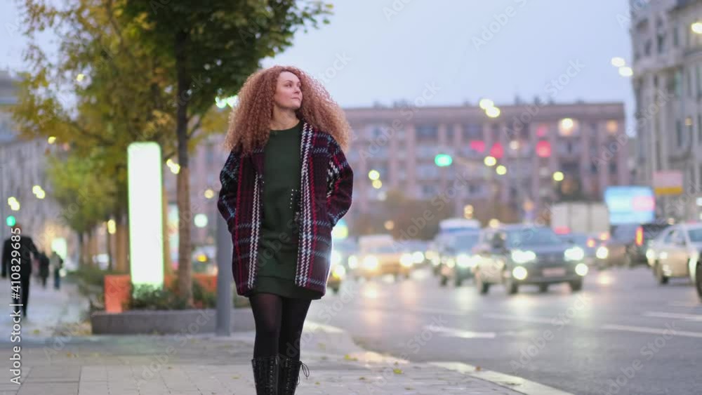 Beautiful young stylish woman walking in the night city streets. alone in a big city. loneliness concept Beautiful young stylish woman walking in the night city streets. alone in a big city. loneliness concept