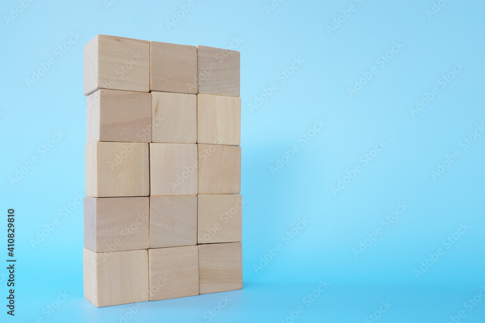 Building blocks tower in blue background with copy space. Stability, achievement and growth concept