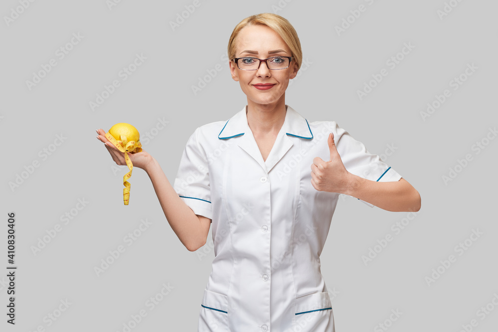 nutritionist doctor healthy lifestyle concept - holding organic lemon fruit and measure tape nutritionist doctor healthy lifestyle concept - holding organic lemon fruit and measure tape