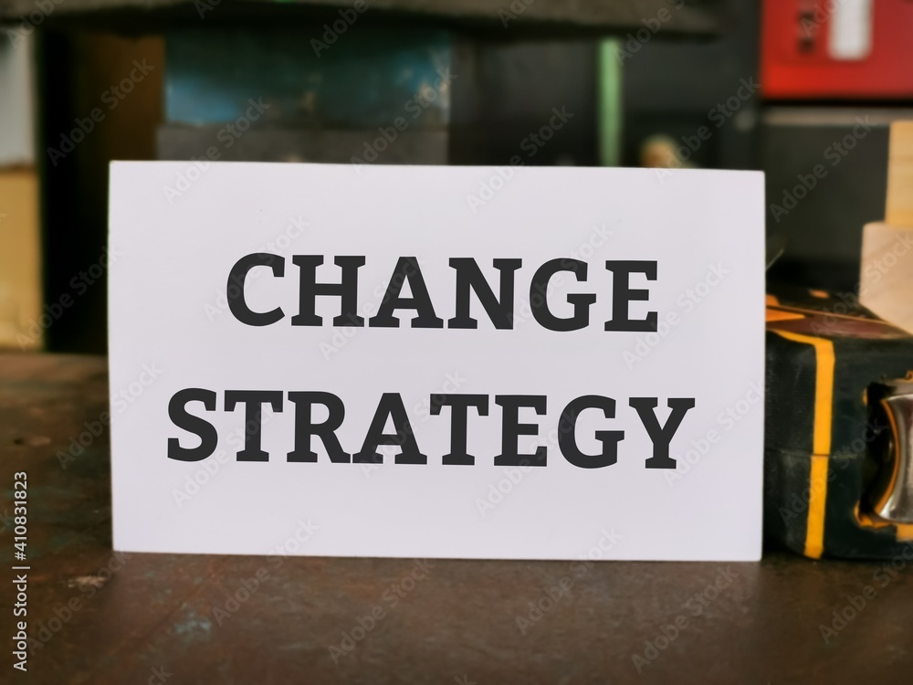 Phrase CHANGE STRATEGY written on white card. Business concept.