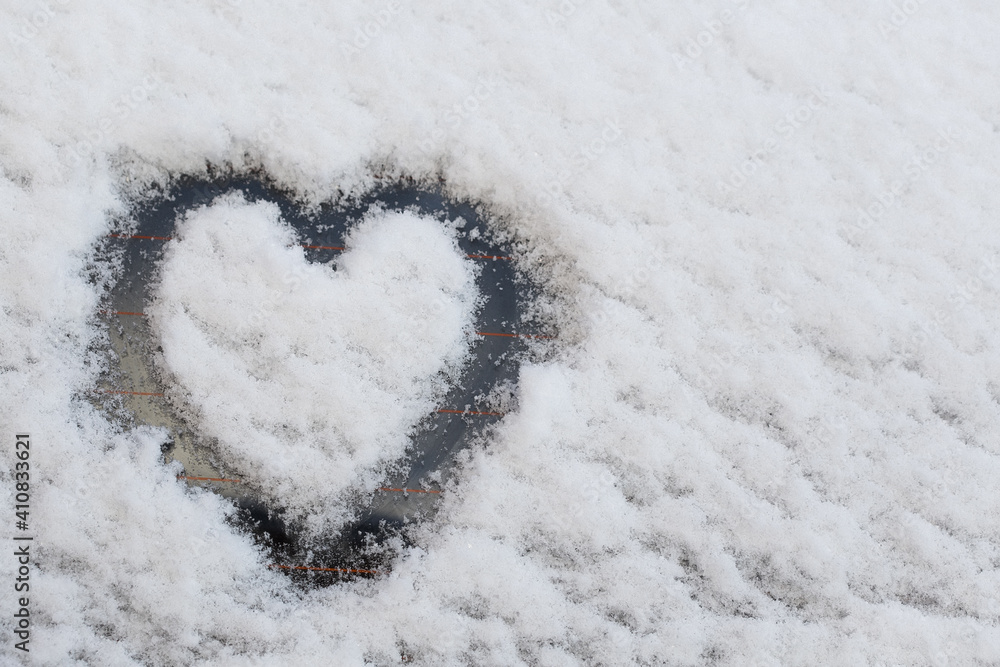The heart is drawn on a snowy surface.
