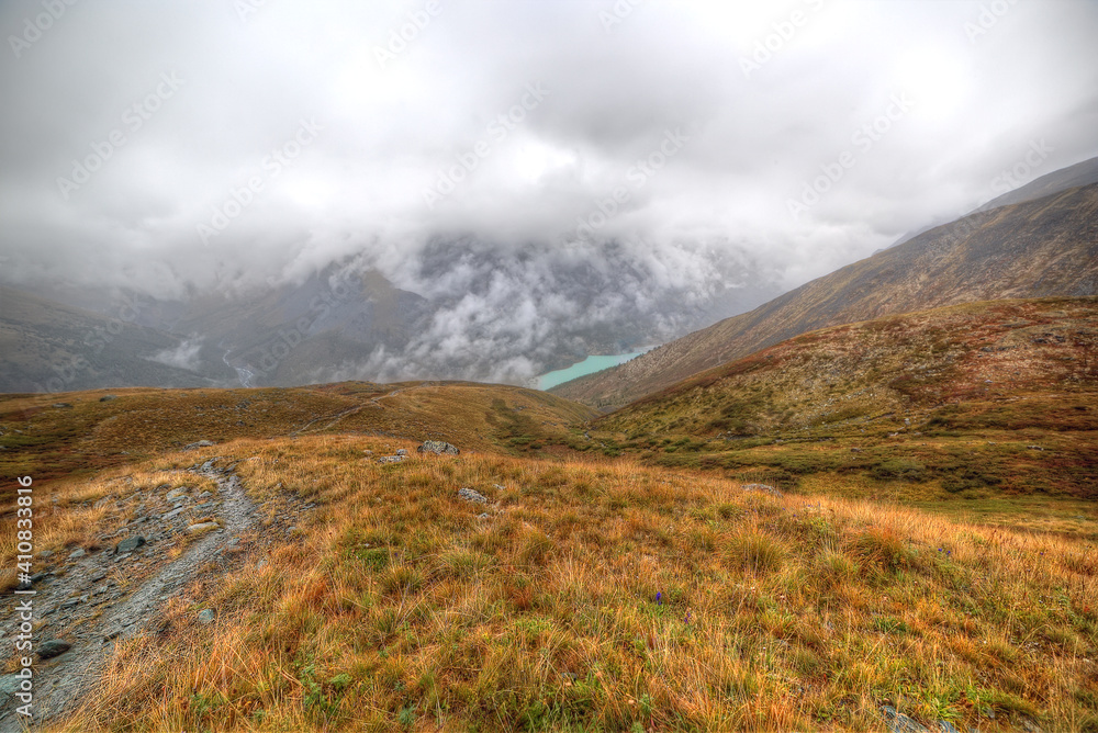 Mountain landscape. Mountain valley with mountains and clouds in the sky.