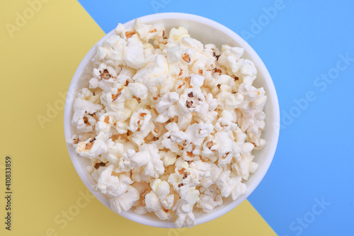 Popcorn in bowl on a red background. Close up. Top view
