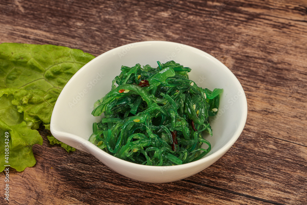 Green Chuka Seaweed Salad Isolated on White Background Top View. Wakame Sea Kelp Salat Green Chuka Seaweed Salad Isolated on White Background Top View. Wakame Sea Kelp Salat