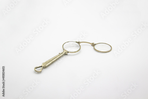 Old vintage lorgnette from the middle of the nineteenth century on the white background