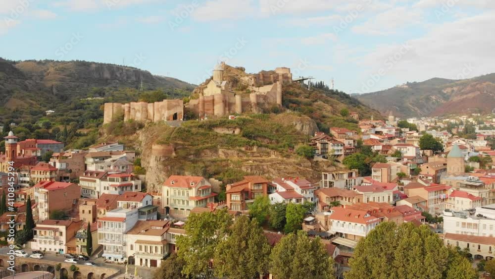 Georgia capital Tbilisi old town buildings and Narikala fortress landmark on hill.Sightseeing in Georgia concept Georgia capital Tbilisi old town buildings and Narikala fortress landmark on hill.Sightseeing in Georgia concept