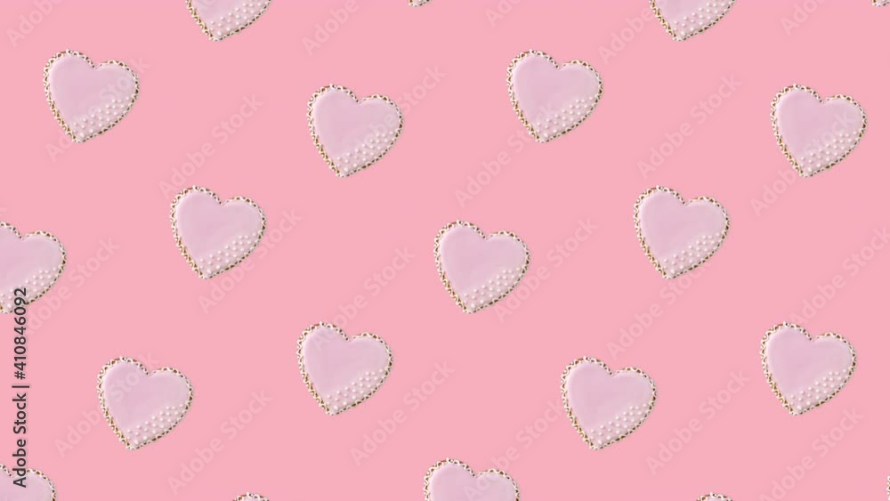 seamless looping animation with pattern of heart shaped cookies decorated by pink glaze on a pastel background, diagonal movement seamless looping animation with pattern of heart shaped cookies decorated by pink glaze on a pastel background, diagonal movement