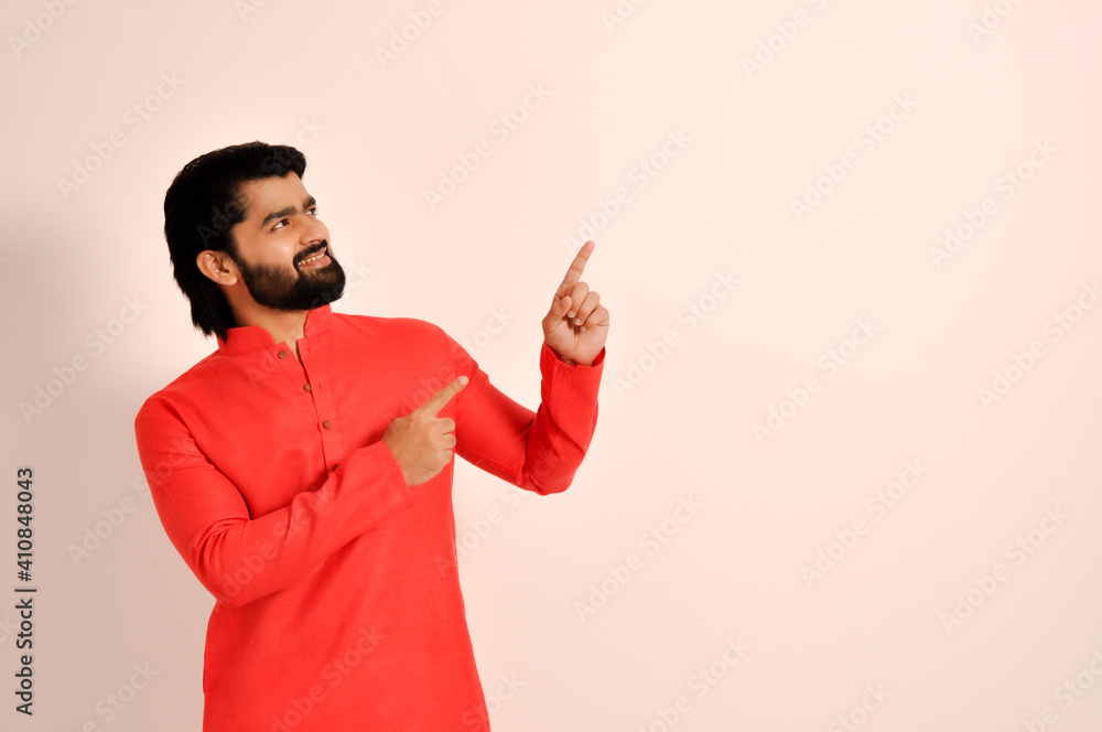 handsome indian man wearing kurta and pointing with both hands handsome indian man wearing kurta and pointing with both hands