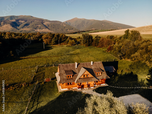 Wooden cottage in nature in sunny day. Recreation center in the mountains. Modern eko hausing in nature. photo