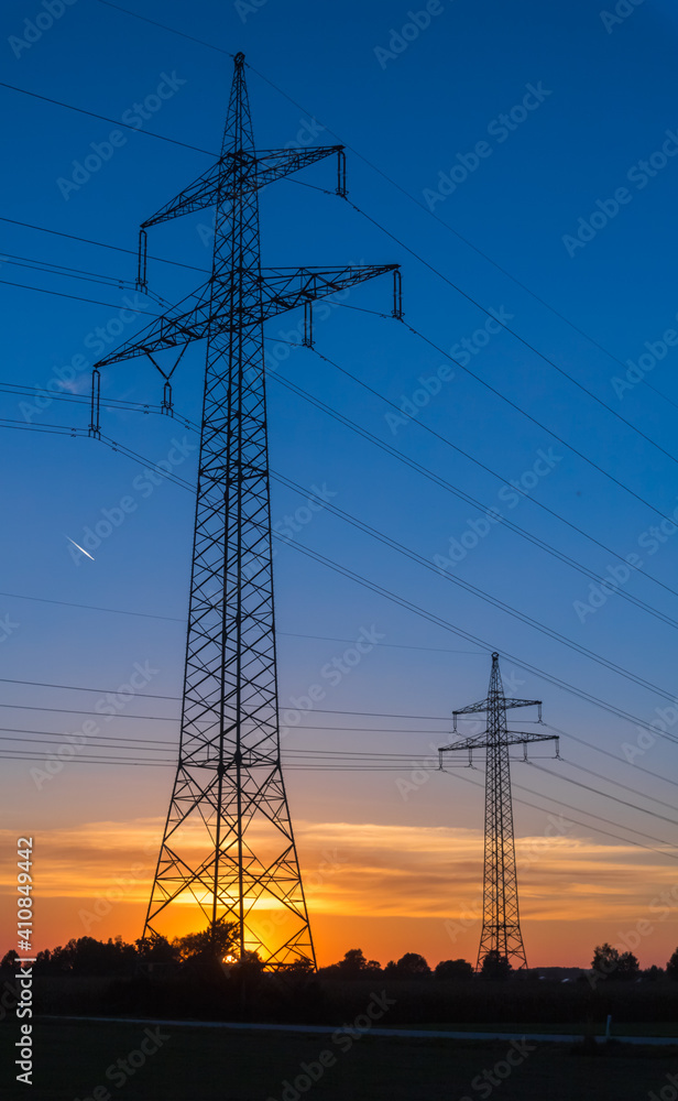 Beautiful sunset with overland high voltage lines near Tabertshausen, Bavaria, Germany