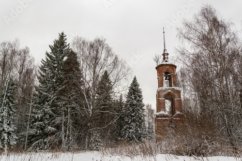 landscape a ruined bell tower in a winter forest